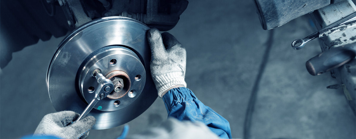 Mechanic fitting a new brake disc - Car Repairs Newcastle Upon Tyne